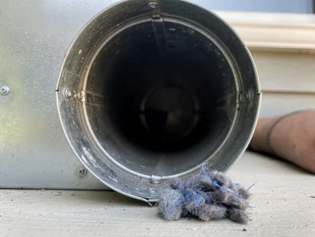 St. Petersburg Dryer Vent Cleaning technician using specialized equipment to clear severe dryer vent blockage in St. Petersburg